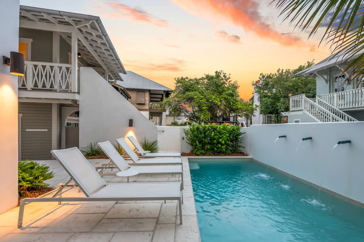 Luxury pool with crisp blue water and upscale outdoor seating.